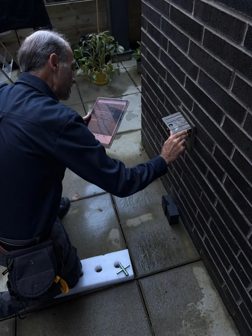 AuditorA home inspector documenting an exterior electrical component.