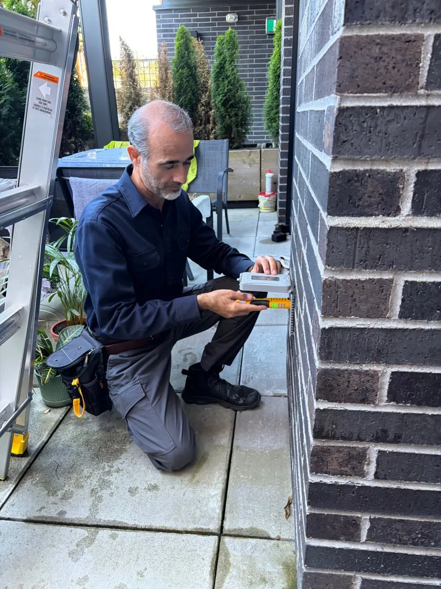 Home inspector using professional testing equipment during a residential inspection.